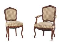A Set of Four Louis XV Style Carved Walnut Chairs