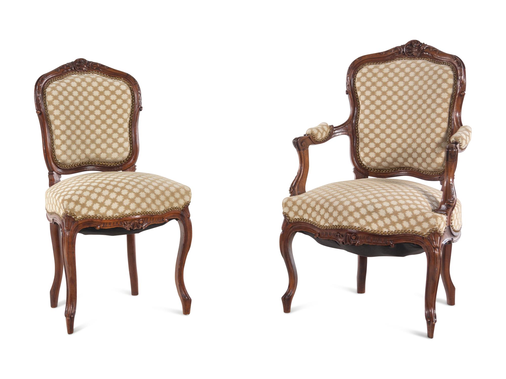 A Set of Four Louis XV Style Carved Walnut Chairs
