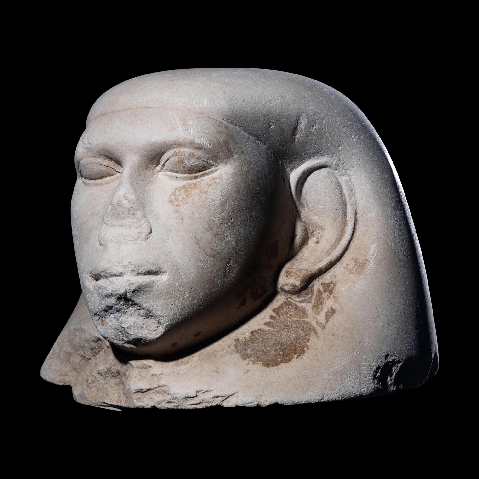 An Egyptian Limestone Canopic Jar Lid