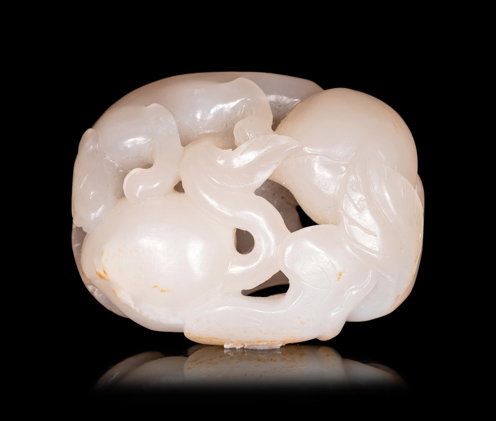 A White Jade Carving of Squirrel and Peaches