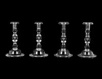 A Set of Four Steuben Glass Candlesticks