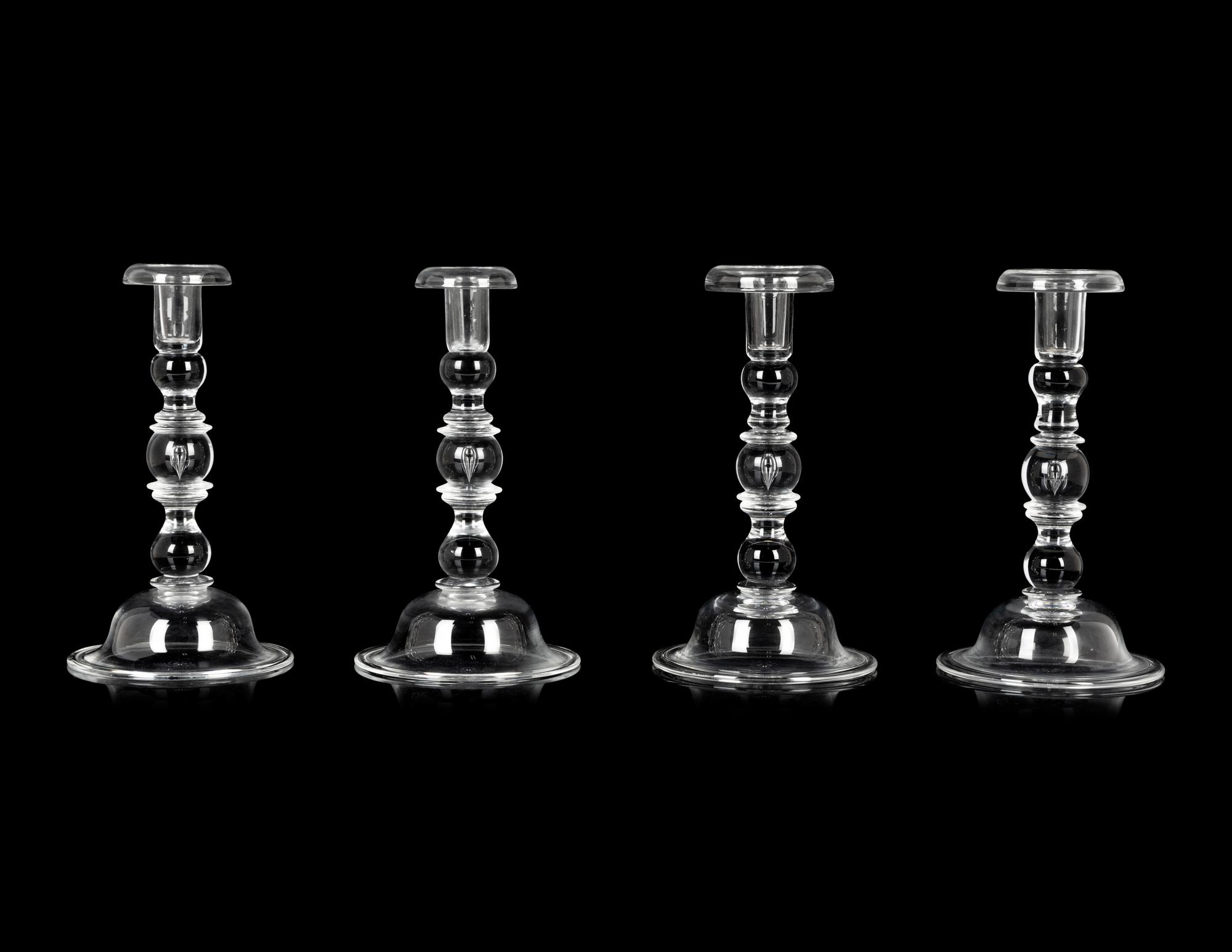 A Set of Four Steuben Glass Candlesticks