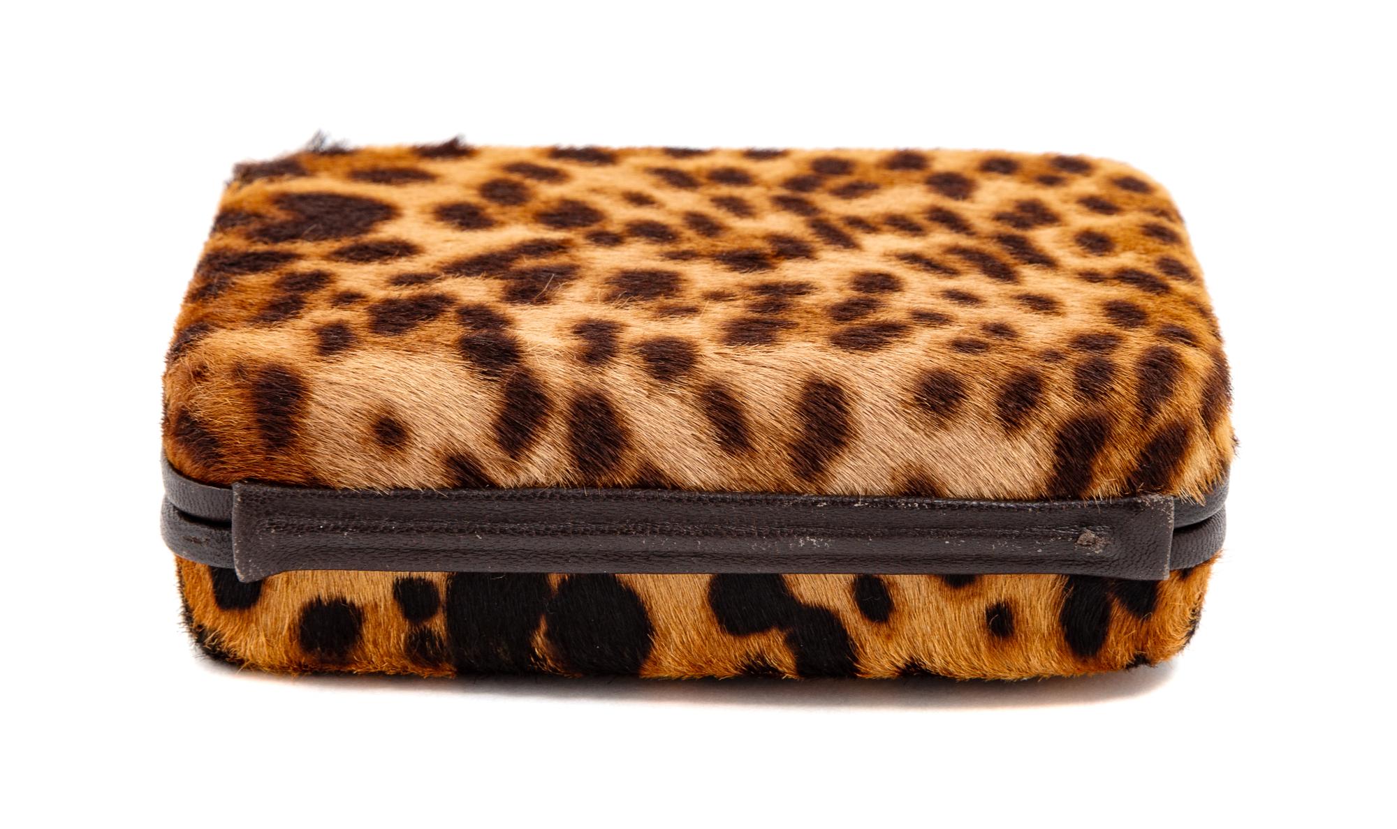 A Christian Louboutin Leopard Print Pony Hair Clutch, 4" H x 5.5" W x 1.5" D.