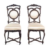 A Pair of Louis XV Style Ebonized and Gilded Side Chairs