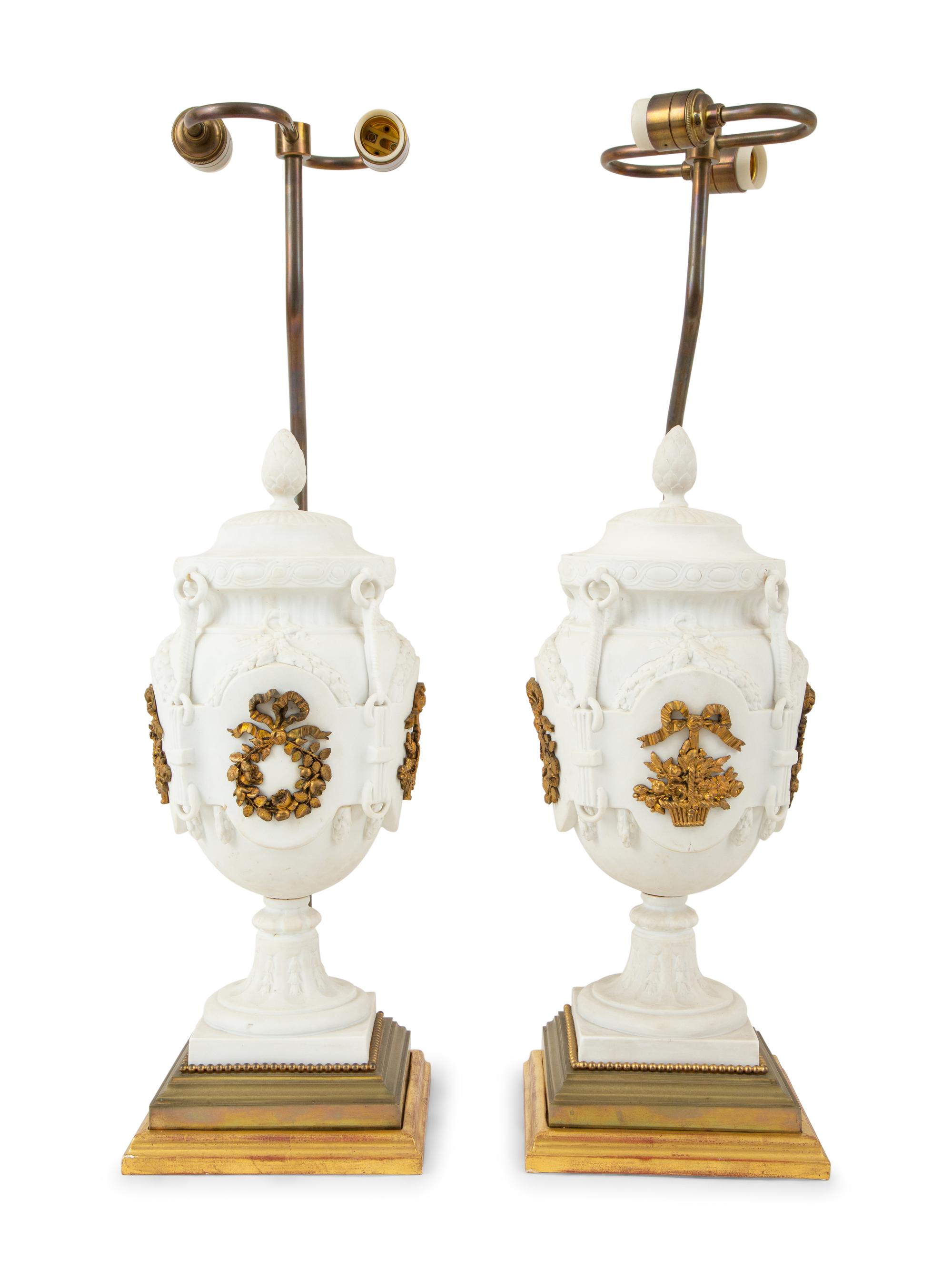 A Pair of Continental Bisque Porcelain Urns with Gilt Metal Mounts