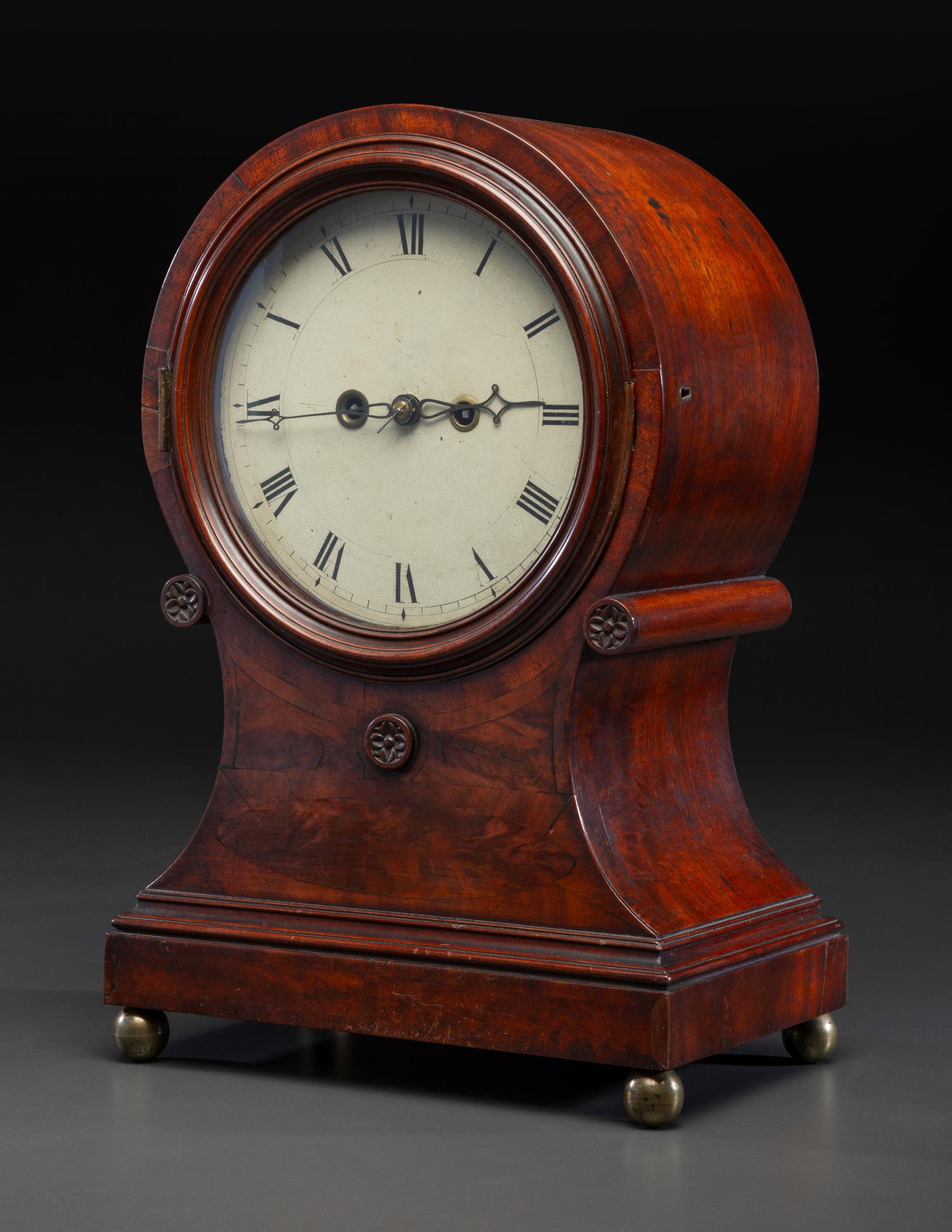 A Federal Carved and Figured Mahogany Balloon-Form Bracket Clock