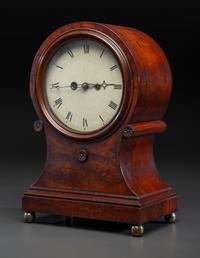 A Federal Carved and Figured Mahogany Balloon-Form Bracket Clock