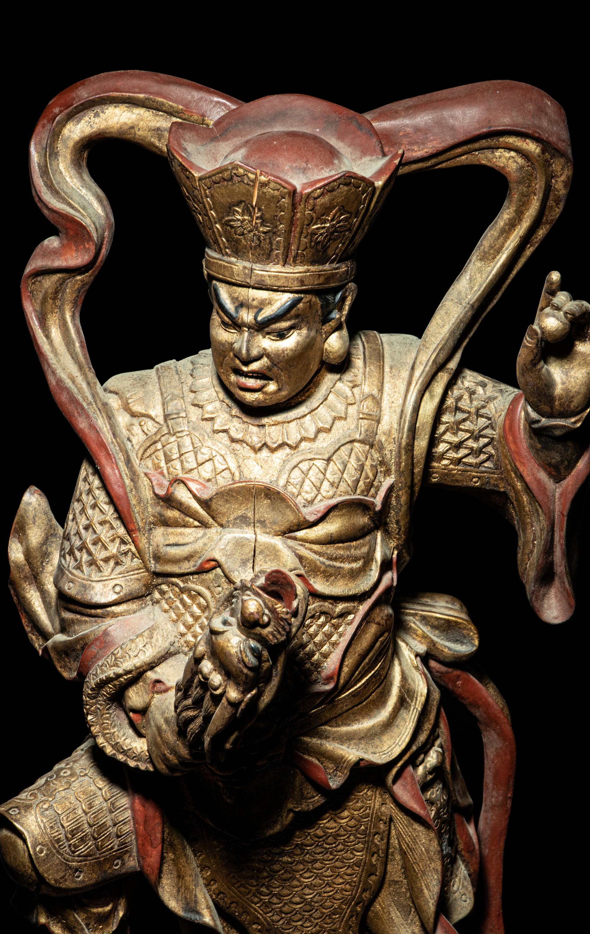 A Set of Four Gilt and Red Lacquered Wood Figures of Guardians
