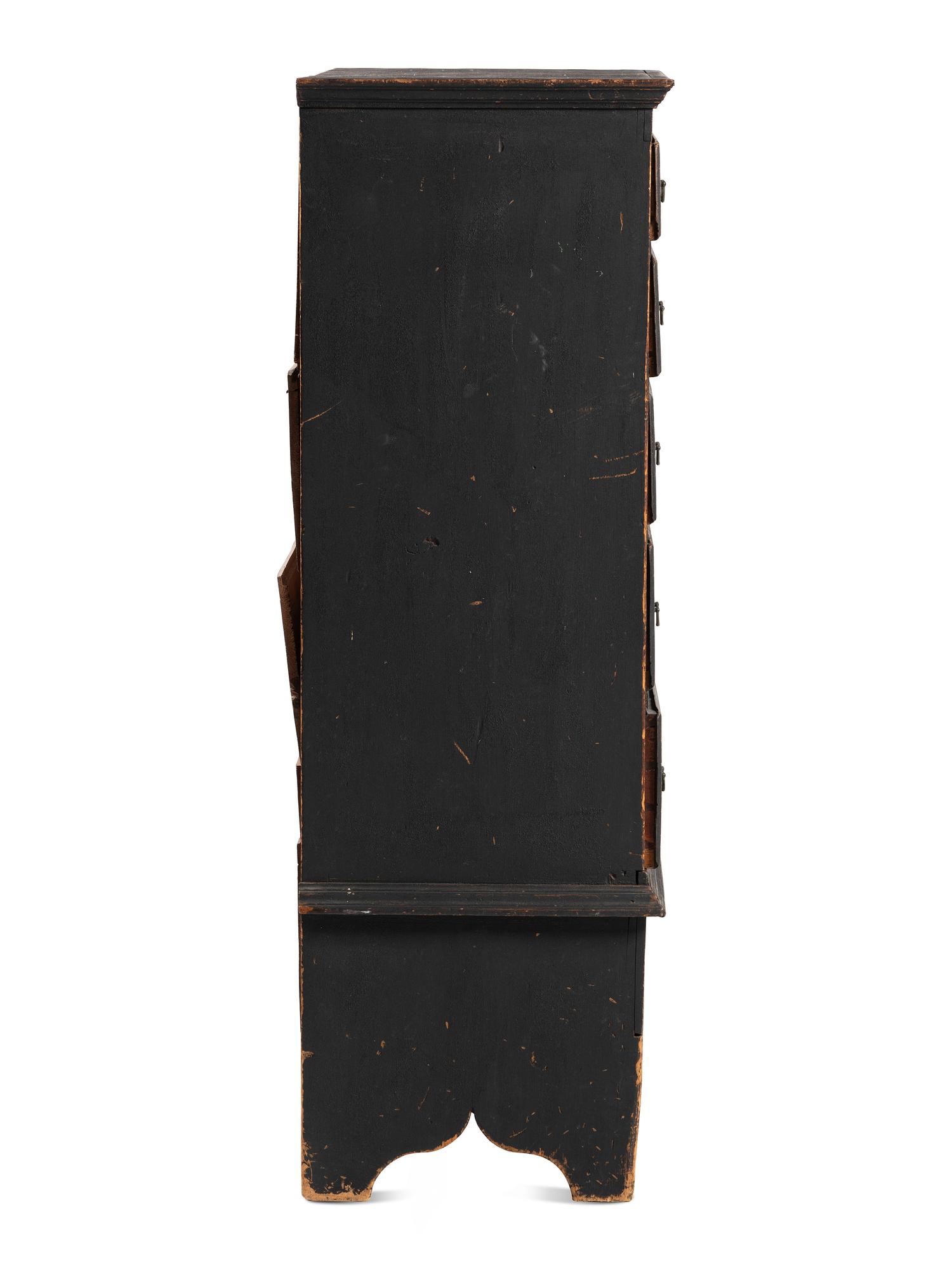 A Country Queen Anne Black Painted Cherrywood and Pine Tall Chest of Drawers, 18th Century