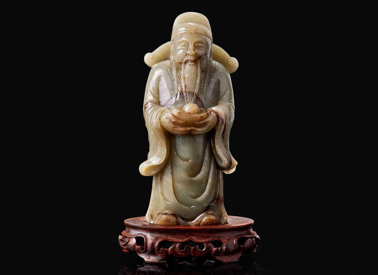 A Chinese carved celadon jade figure of a civil deity, possibly Caishen 青玉雕人物 可能為財神