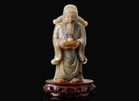 A Chinese carved celadon jade figure of a civil deity, possibly Caishen 青玉雕人物 可能為財神
