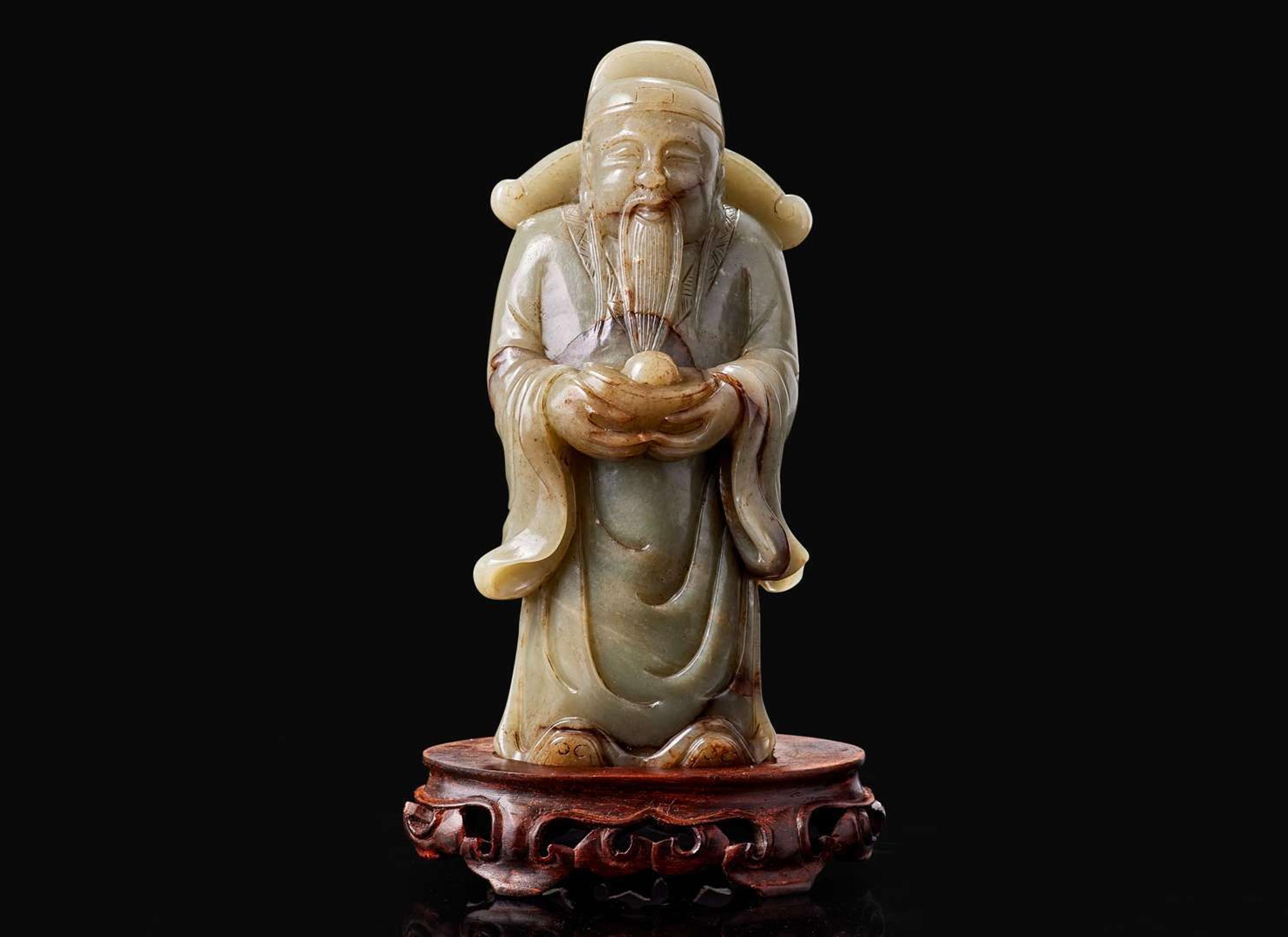 A Chinese carved celadon jade figure of a civil deity, possibly Caishen 青玉雕人物 可能為財神
