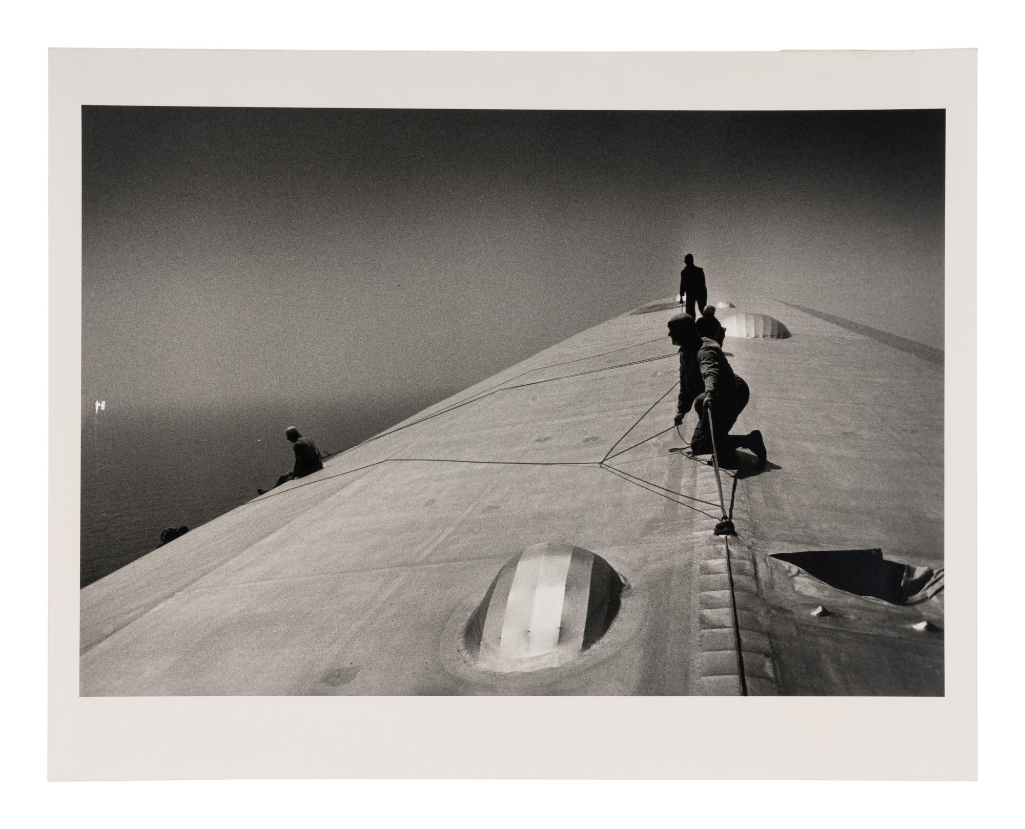EISENSTAEDT, Alfred (1898-1995). A photograph of workers repairing the hull of the Graf Zeppelin.