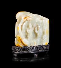 A Chinese Celadon and Russet Jade Boulder