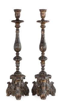 A Pair of Baroque Style Patinated Giltwood Candlesticks Height 30 1/2 inches.
