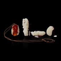A group of three Chinese white jade carvings and a carnelian pendant