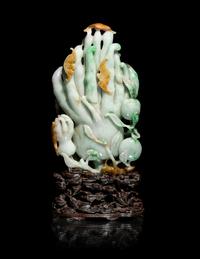 A Chinese Apple Green and Russet Jadeite Carving of Buddha's Hand Citron