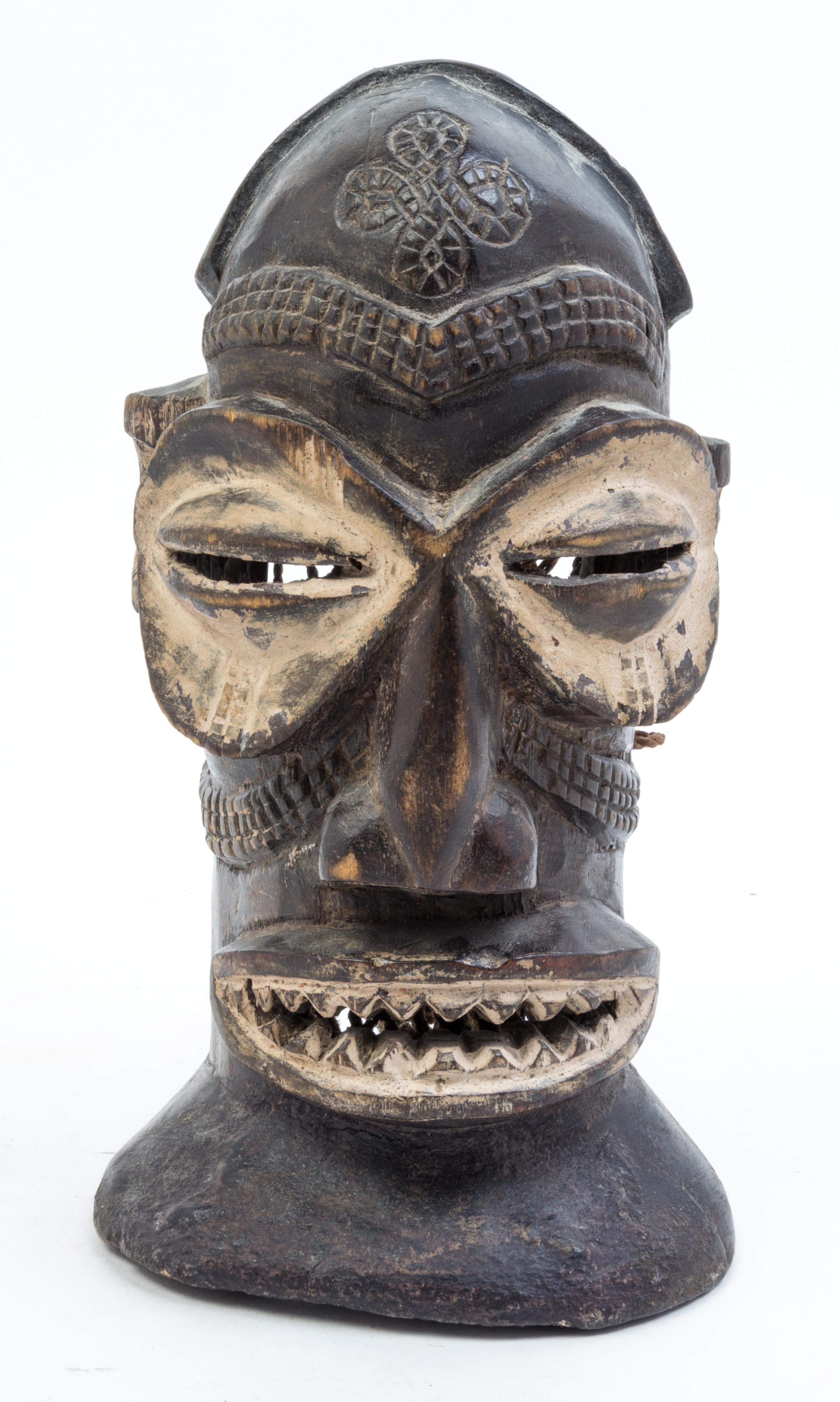 A Group of Four Masks Height of largest 14 1/2 inches.