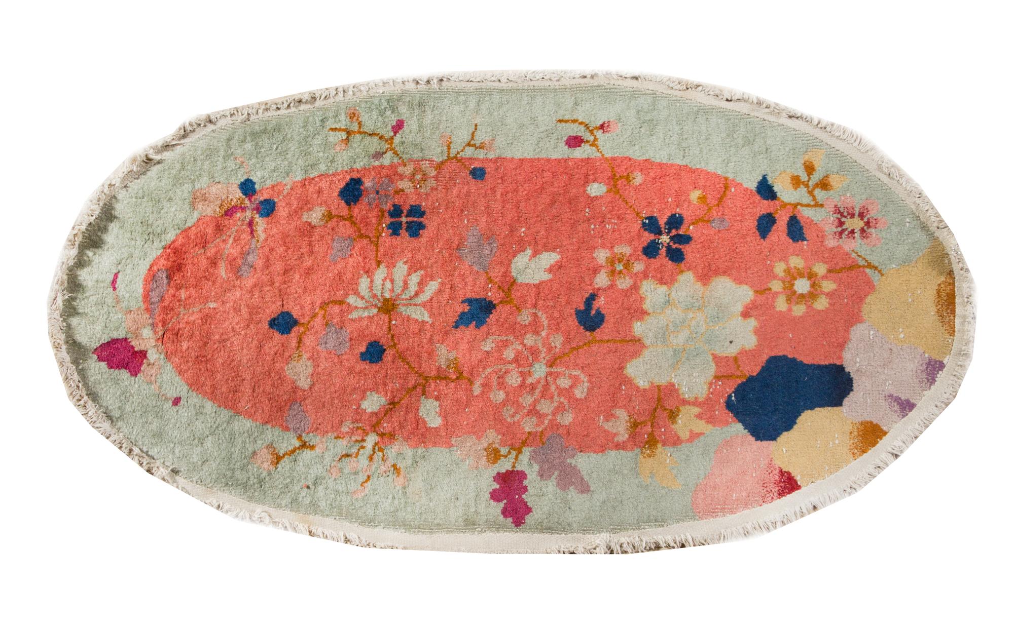 An Oval Chinese Wool Rug 3 feet 10 inches x 1 foot 11 inches. — EARLY TO MID 20TH CENTURY