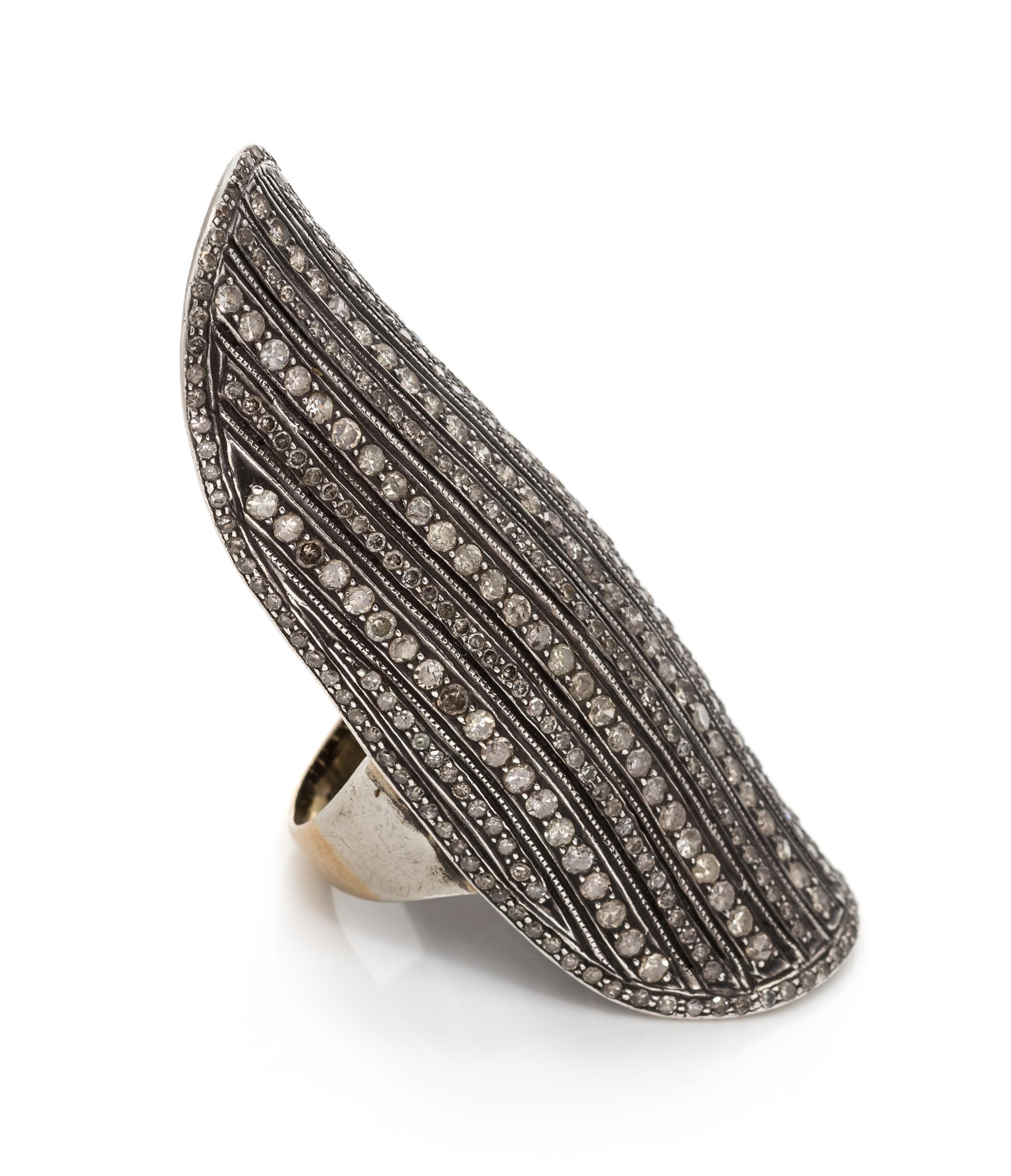 A Sterling Silver, 18 Karat Yellow Gold and Diamond Knuckle Ring, 8.75 dwts.