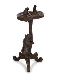 A Swiss Black Forest Carved Wood Smoking Table