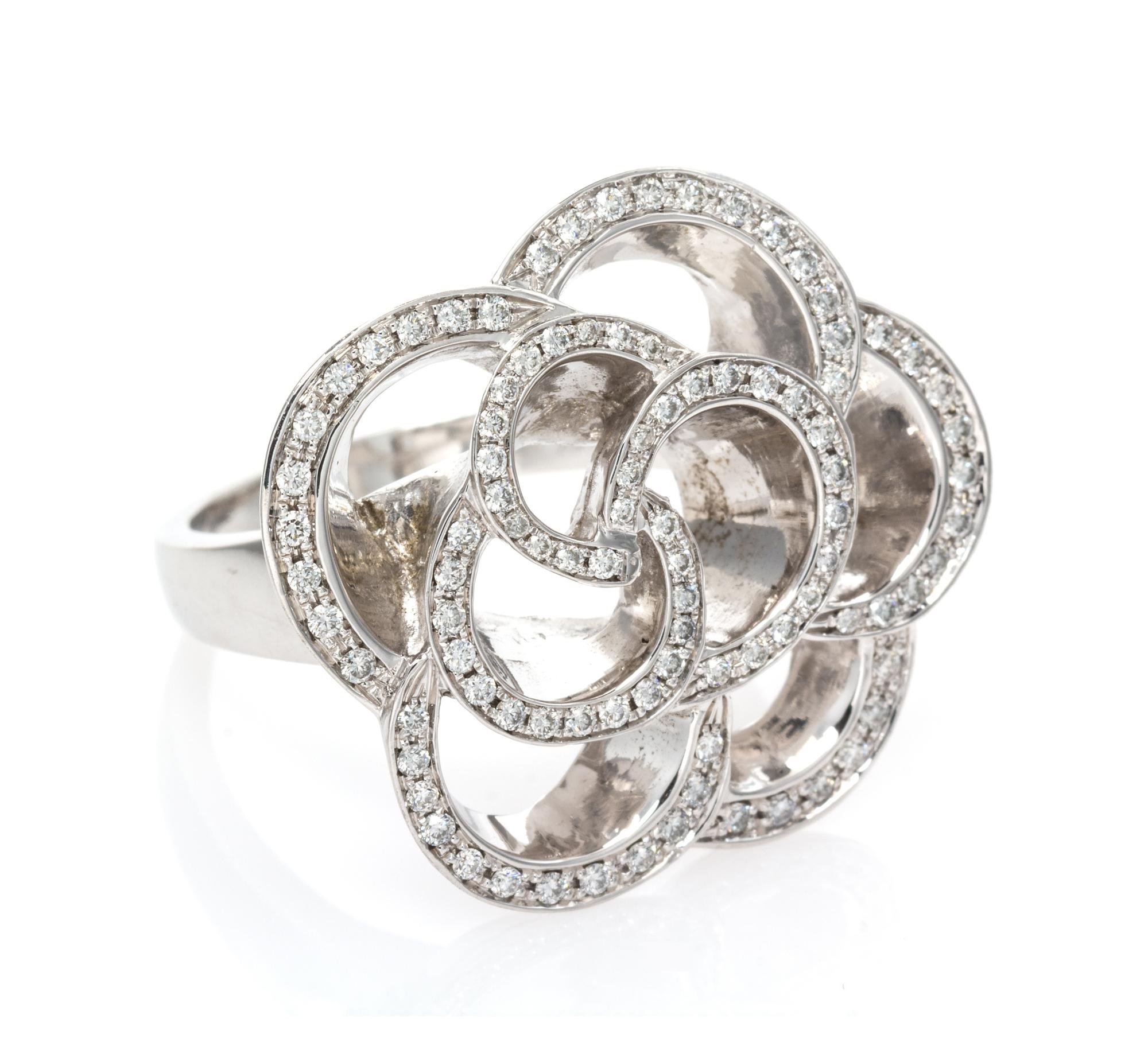 An 18 Karat White Gold and Diamond Floral Motif Ring, 12.15 dwts.