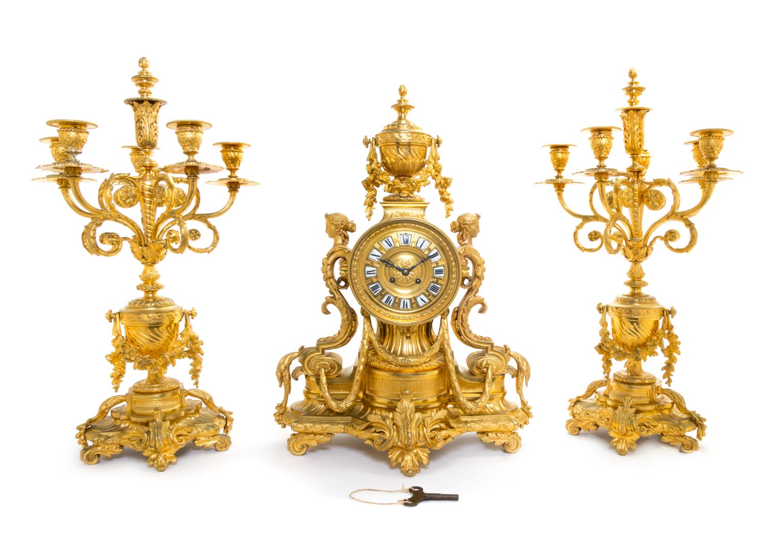 A French Gilt Bronze Clock Garniture Height of candelabra 24 1/2 inches. — 19TH CENTURY