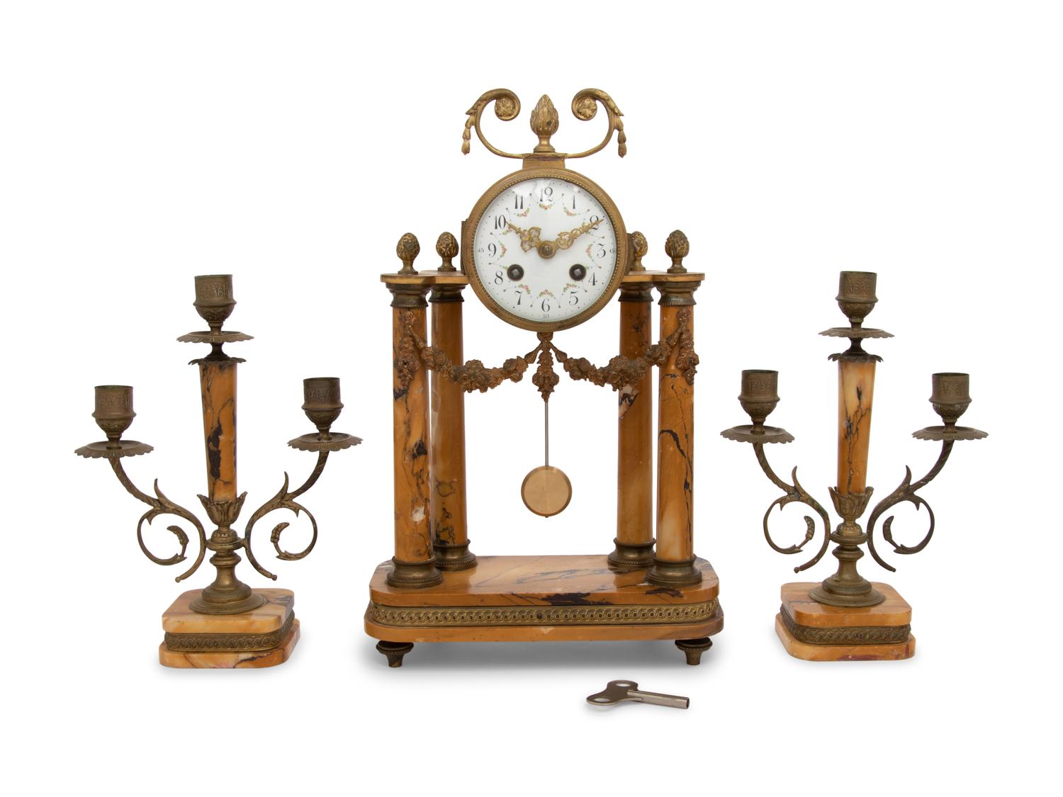 A French Gilt Metal and Siena Marble Three-Piece Clock Garniture