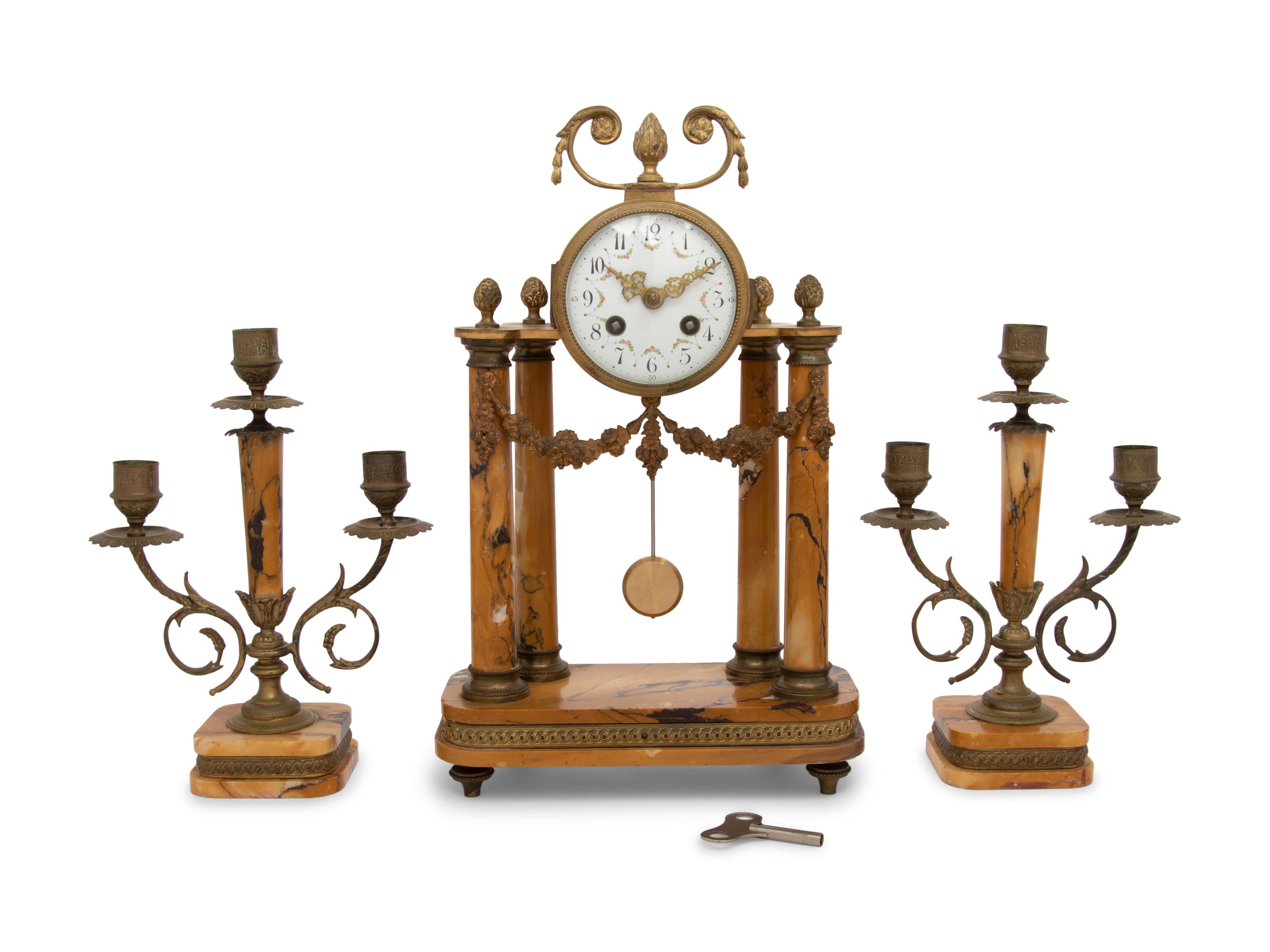 A French Gilt Metal and Siena Marble Three-Piece Clock Garniture