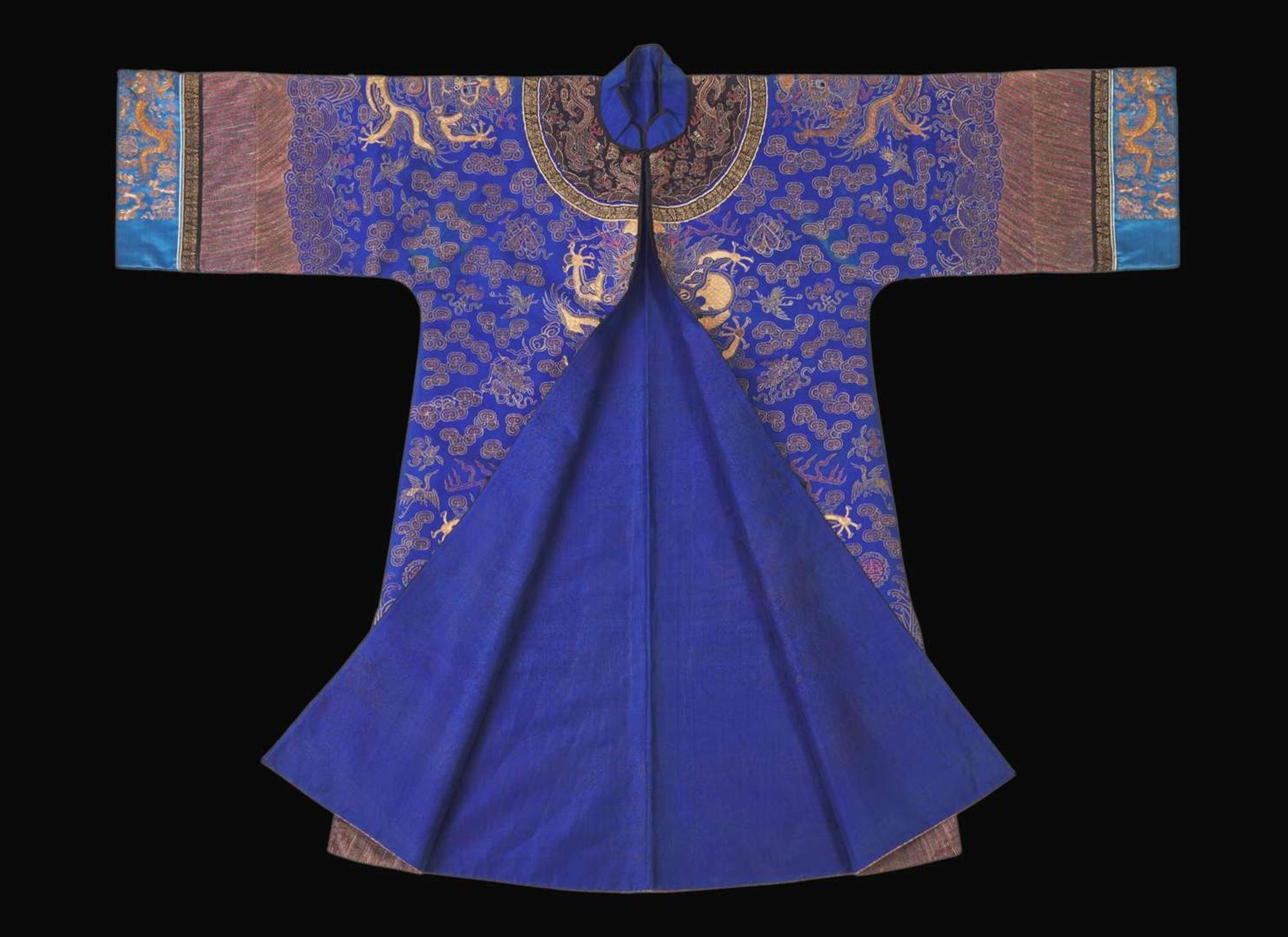 A Chinese embroidered blue silk "Dragon" surcoat, late Qing dynasty 刺繡藍地龍袍 晚清