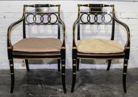 A Pair of Regency Style Parcel Gilt Ebonized Dining Armchairs Height 32 1/2 inches. — 20TH CENTURY