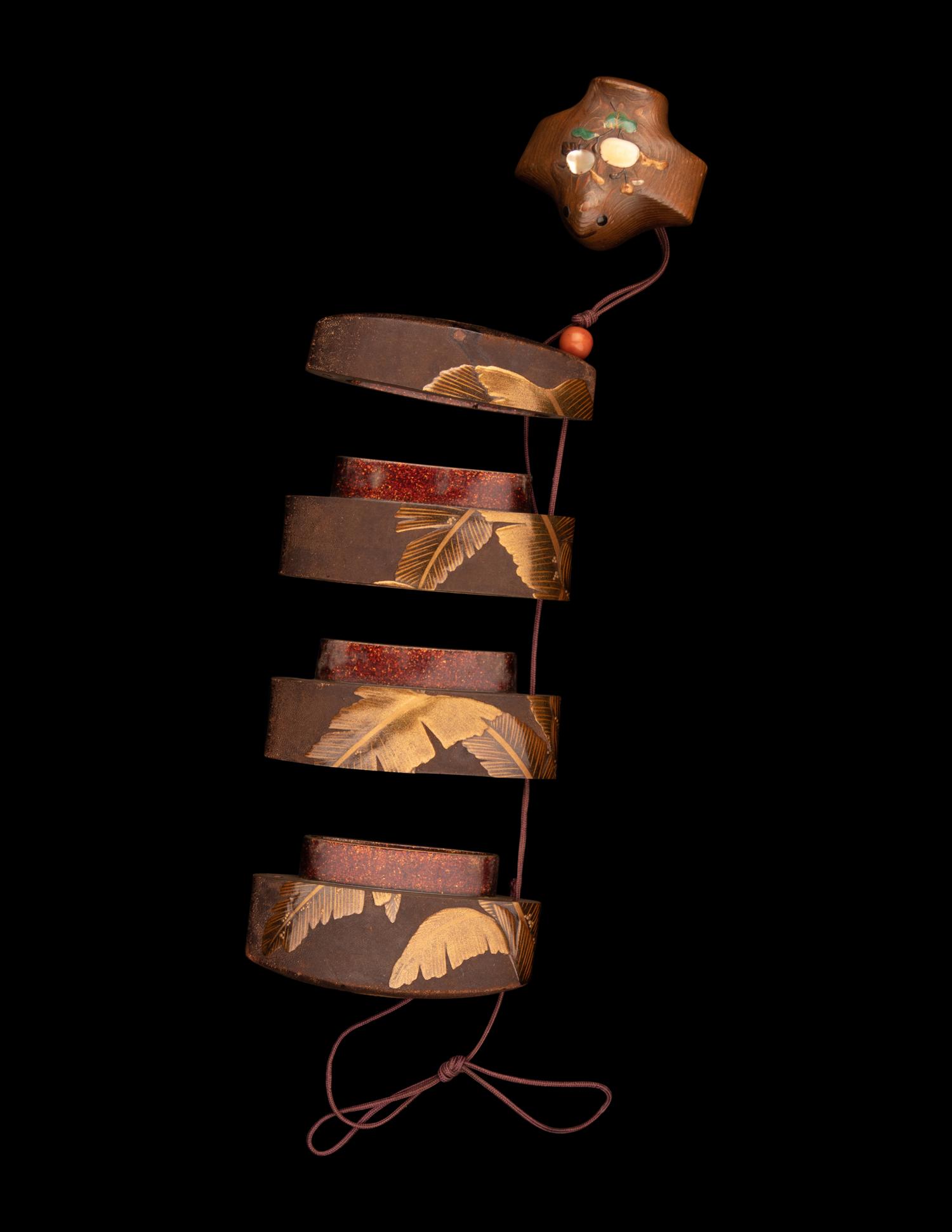 A Japanese Gold Lacquered Wood Three-Case Inro