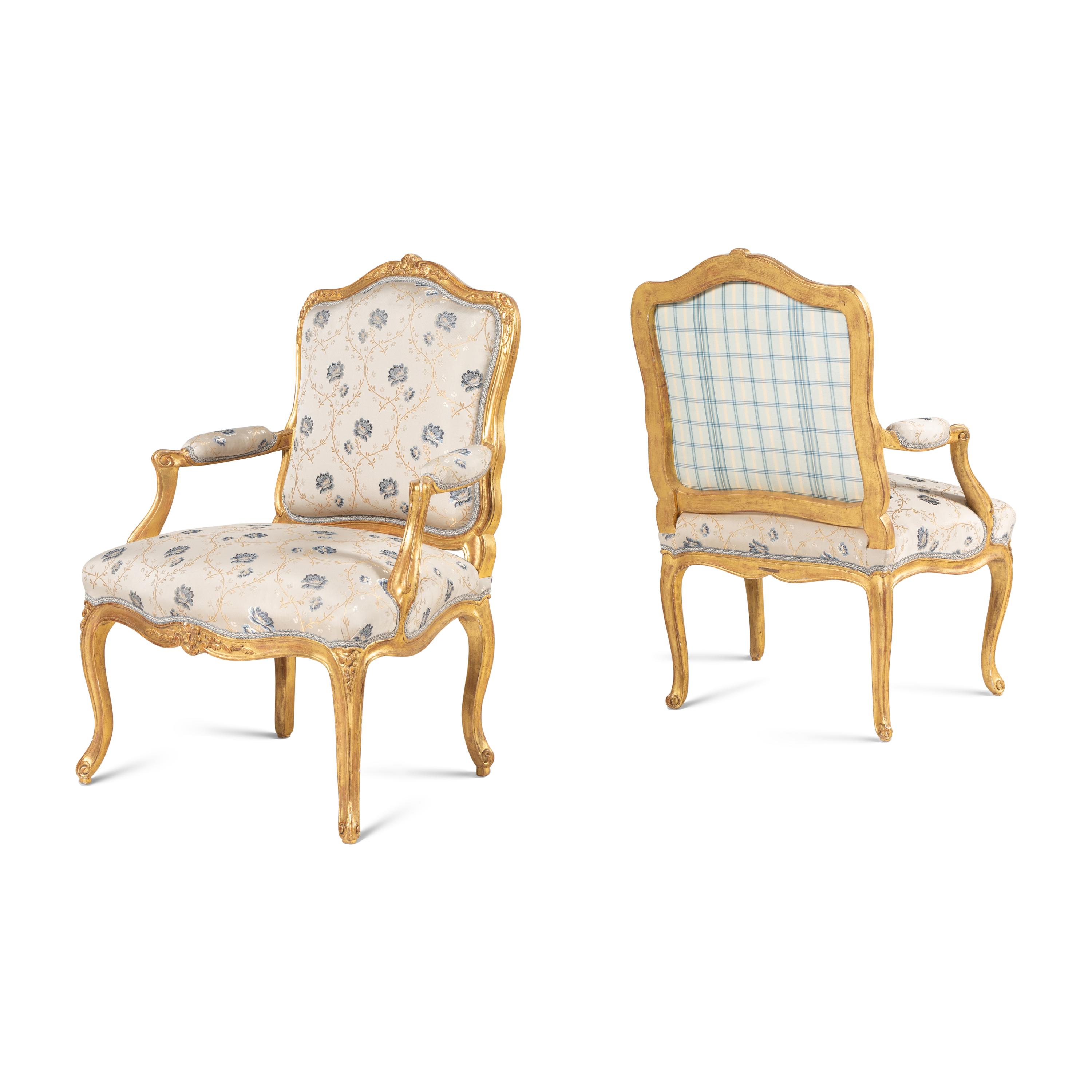A Pair of Louis XV Carved and Giltwood Fauteuils à la Reine