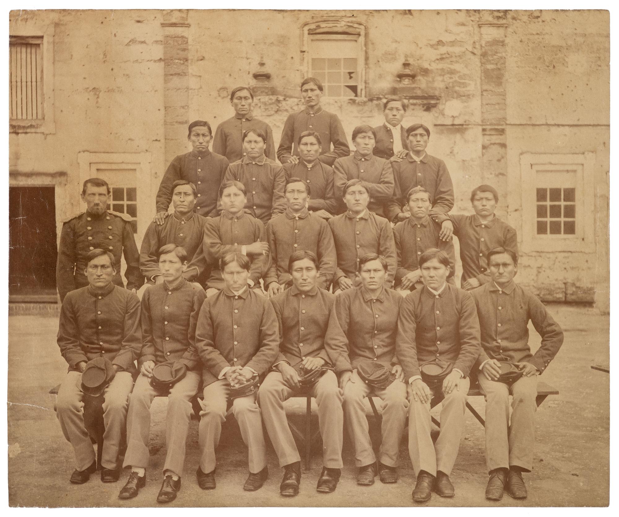 [NATIVE AMERICANS]. Large format photograph of Captain R.H. Pratt with Kiowa and Southern Cheyenne prisoners at Fort Marion. Ca 1878.
