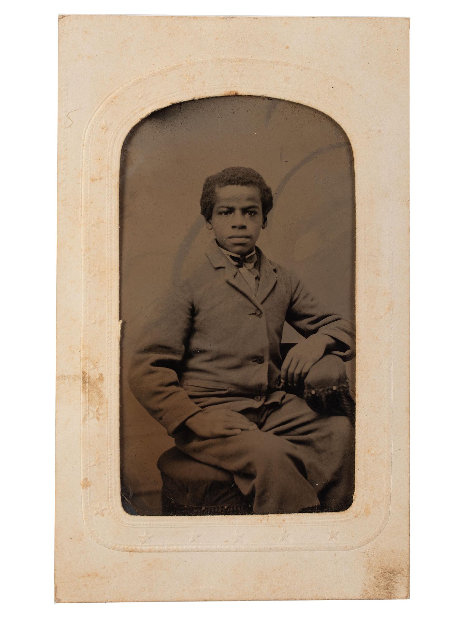 [EARLY PHOTOGRAPHY]. Tintype portrait of a young African American male subject.