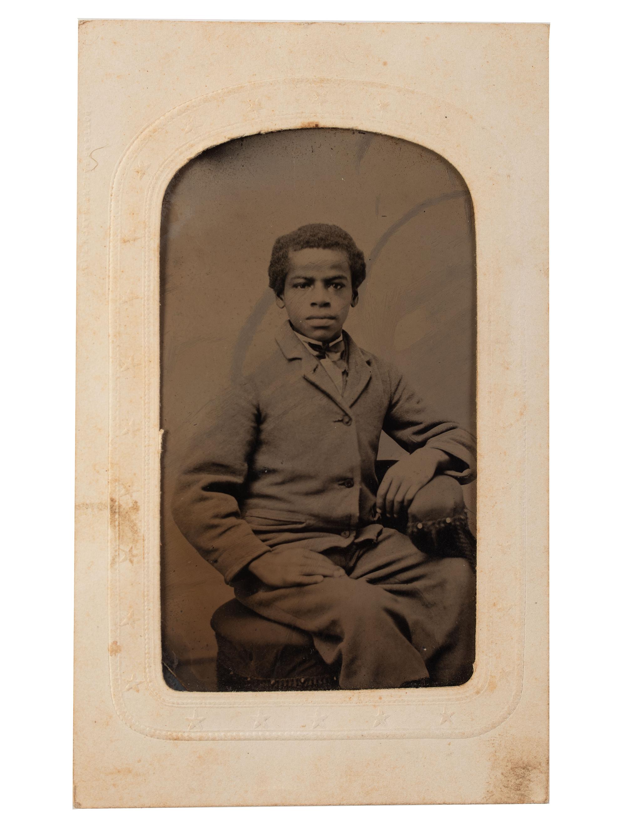 [EARLY PHOTOGRAPHY]. Tintype portrait of a young African American male subject.