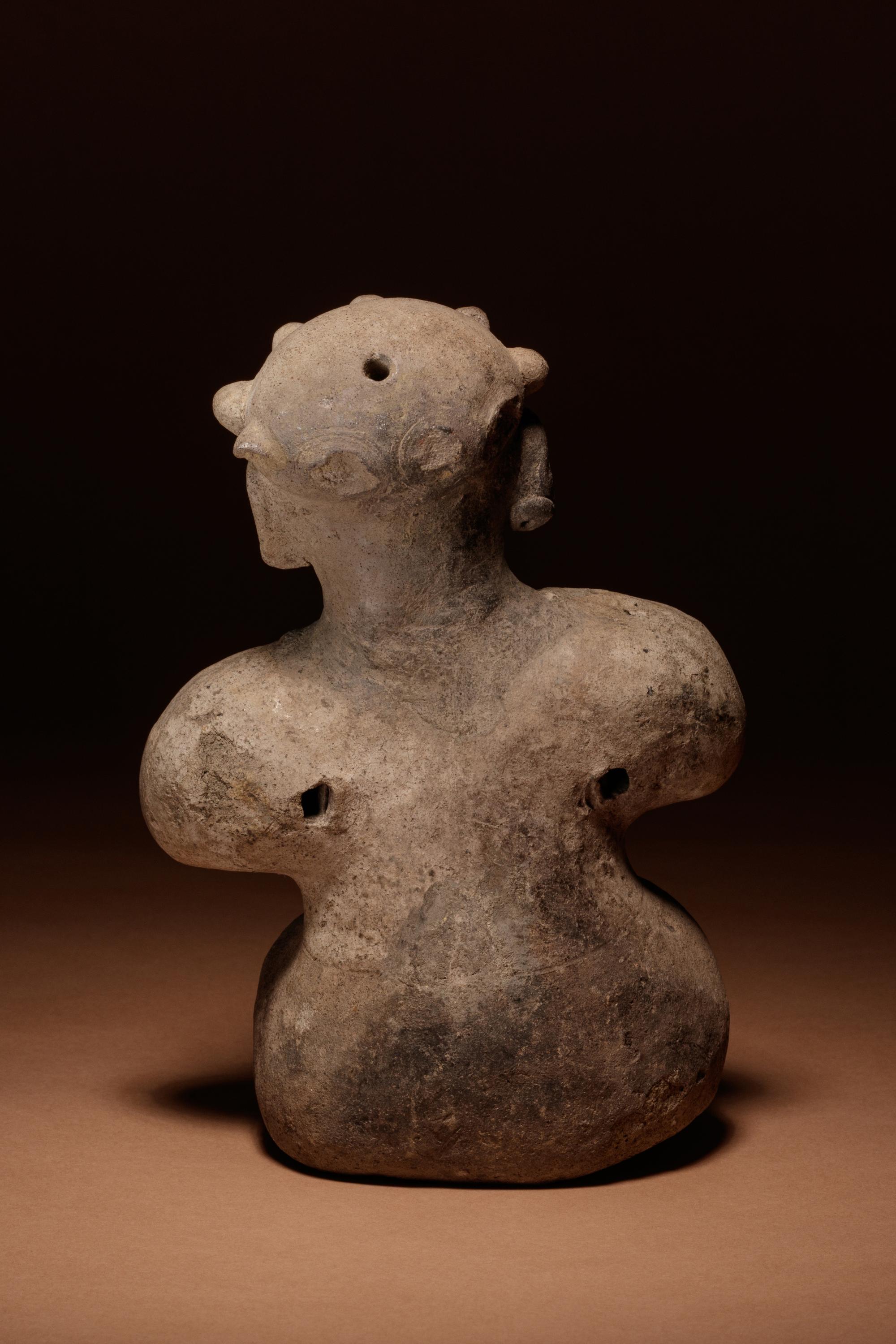 A Tumaco Female Figure Holding Breasts
