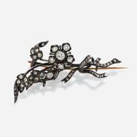 An antique diamond and silver topped gold brooch