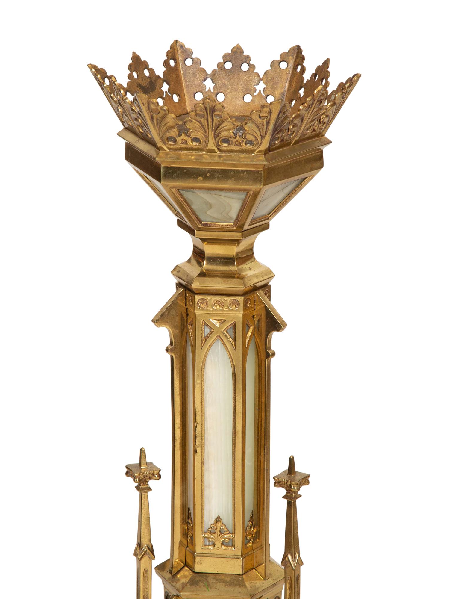 A Pair of Gothic Style Brass and Inset Glass Candlesticks