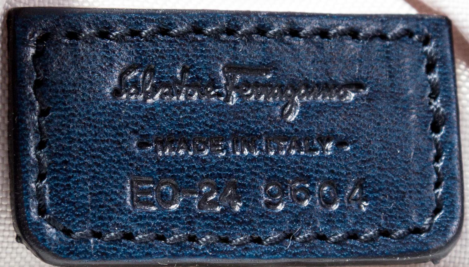 A Salvatore Ferragamo Navy Logo Embossed Leather Tote Bag, 11"H x 15"W x 7.25"D; Strap drop: 8".