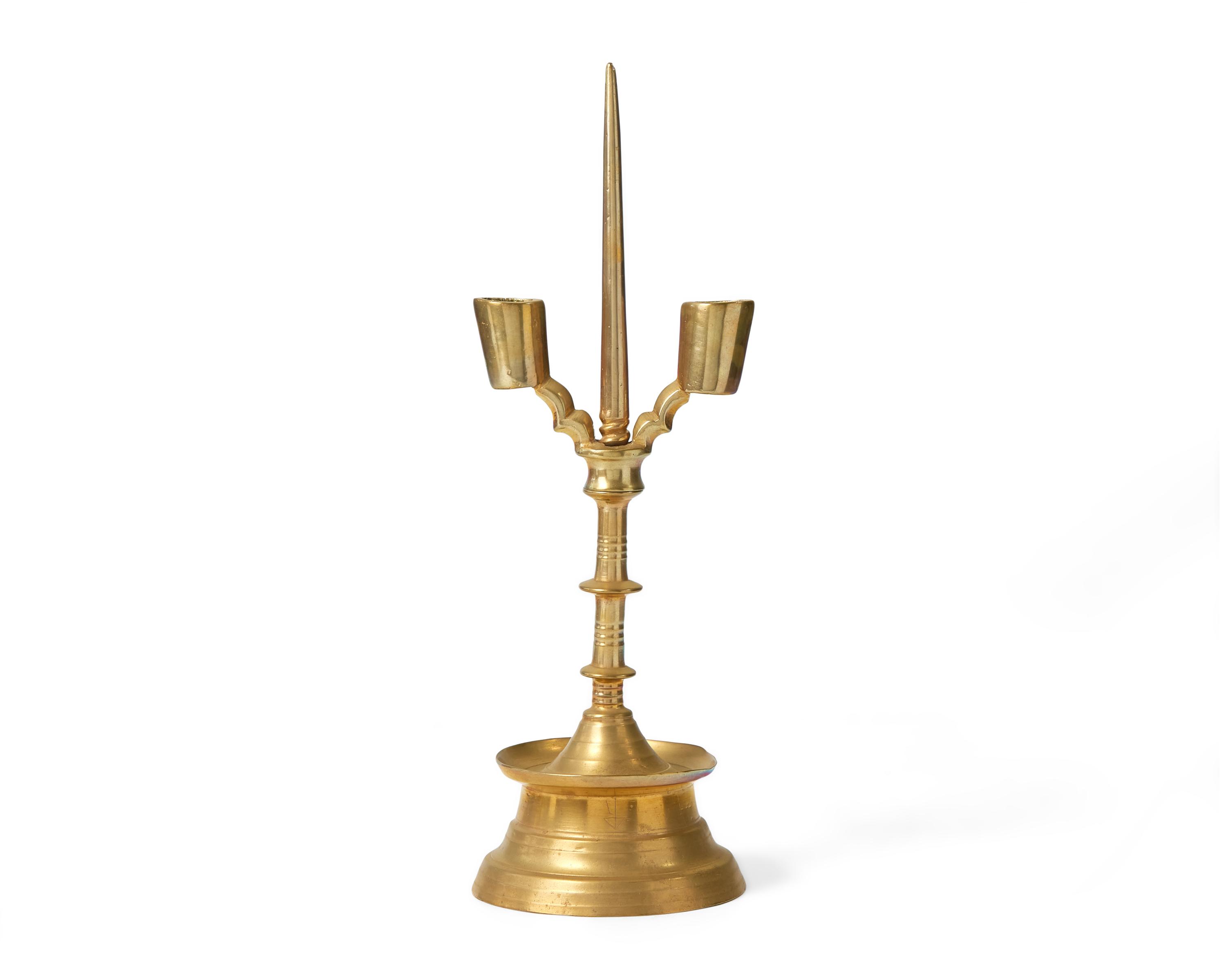 A Flemish Brass Double-Light Candlestick