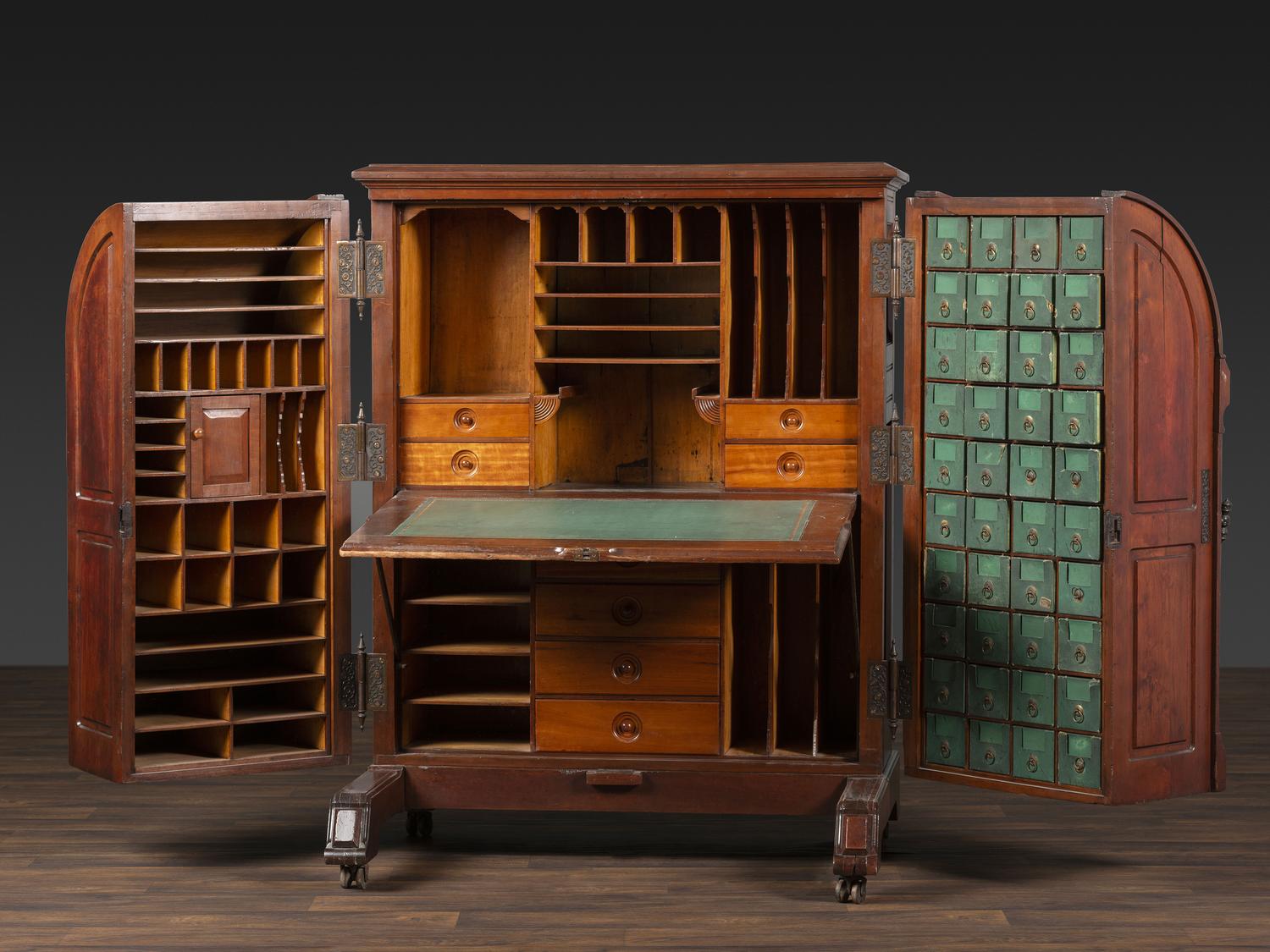 A Carved Walnut Wooton Secretary Desk