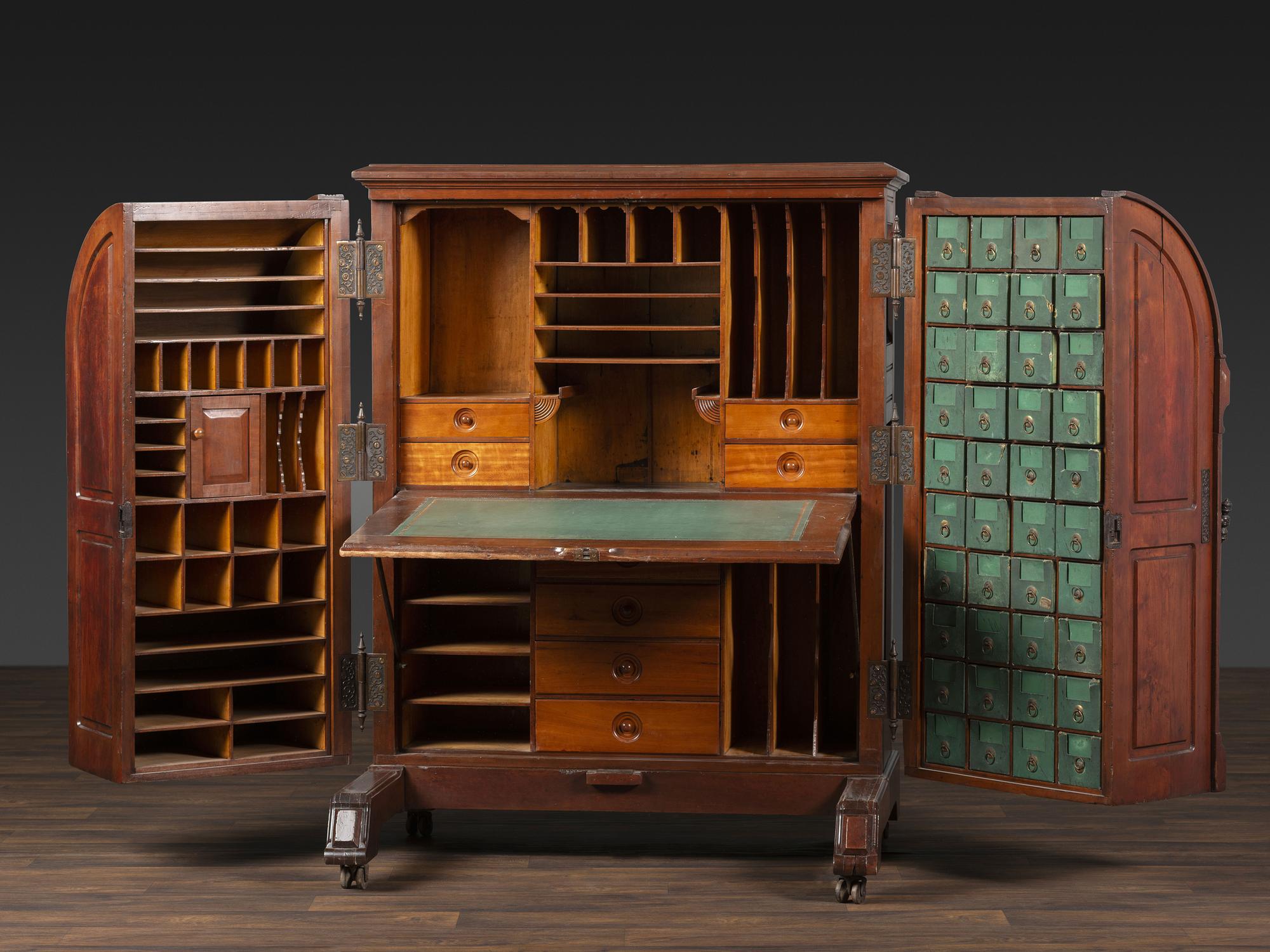 A Carved Walnut Wooton Secretary Desk