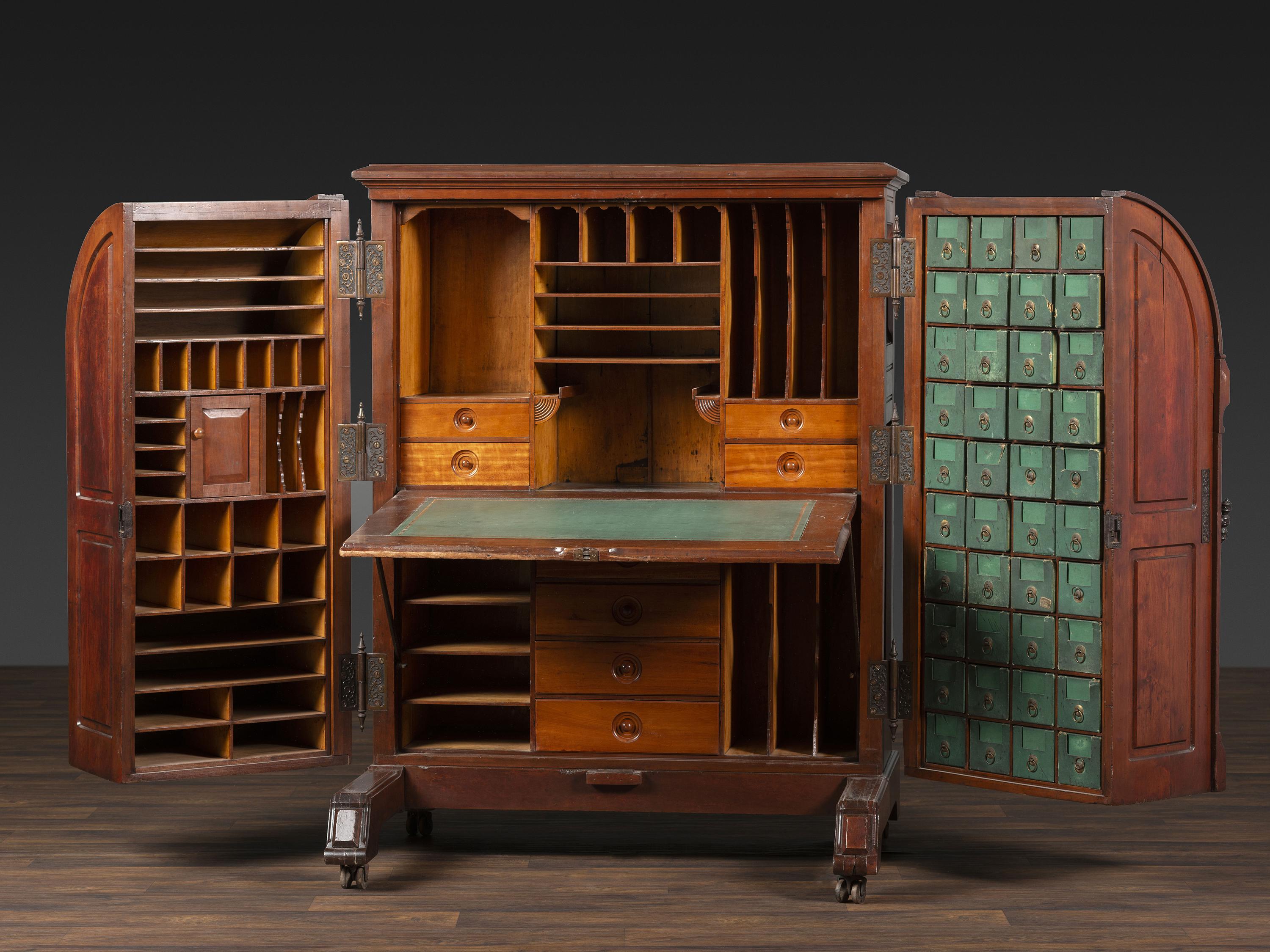 A Carved Walnut Wooton Secretary Desk