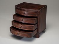 A Miniature Bow Front Chest of Drawers and Drop-Leaf Dining Table
