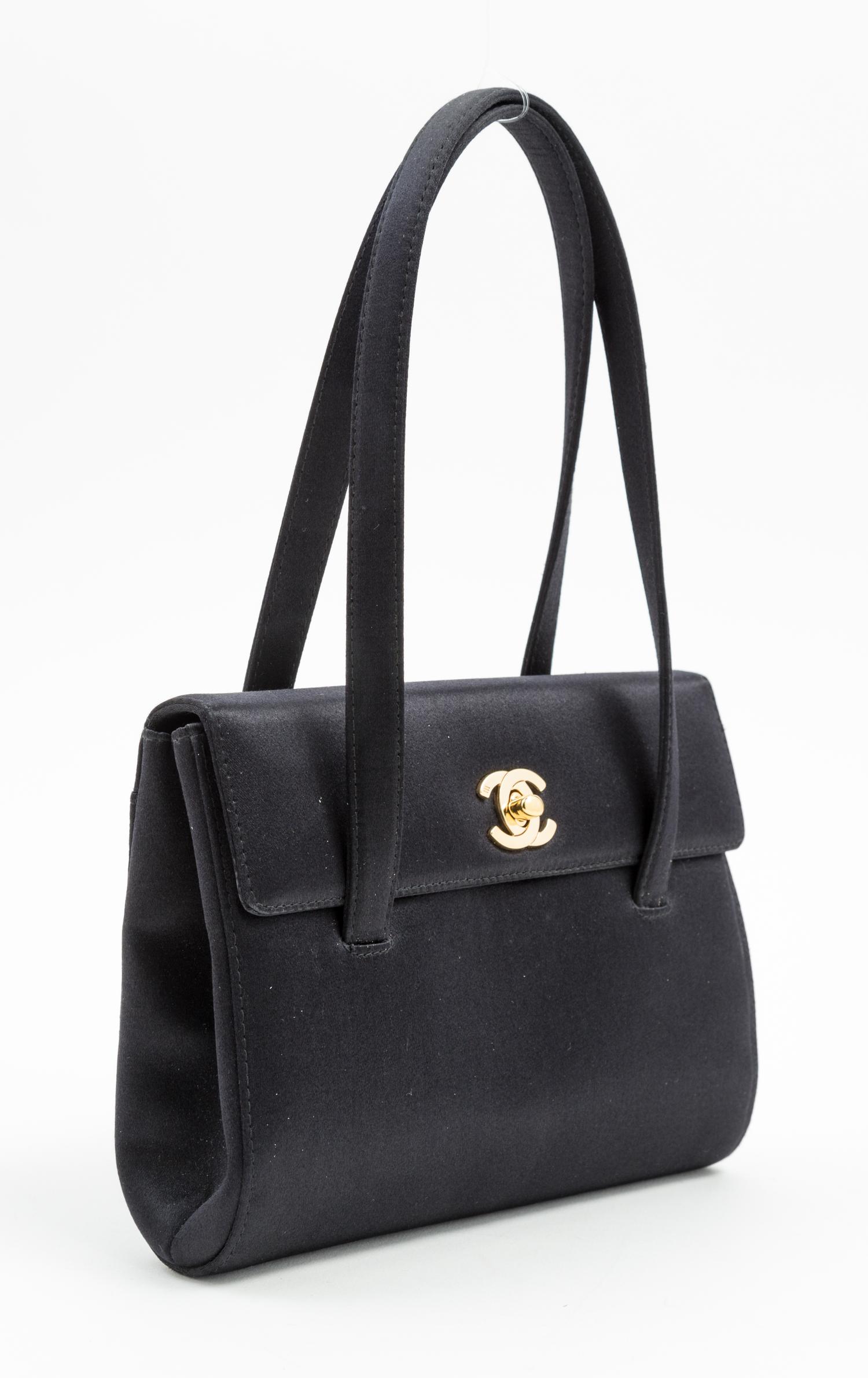 A Chanel Black Satin Small Flap Handbag, 7.5" x 5.5" x 1.75"; Handle drop: 5.5".