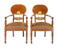 A Pair of Baltic Neoclassical Parcel-Gilt Walnut Armchairs