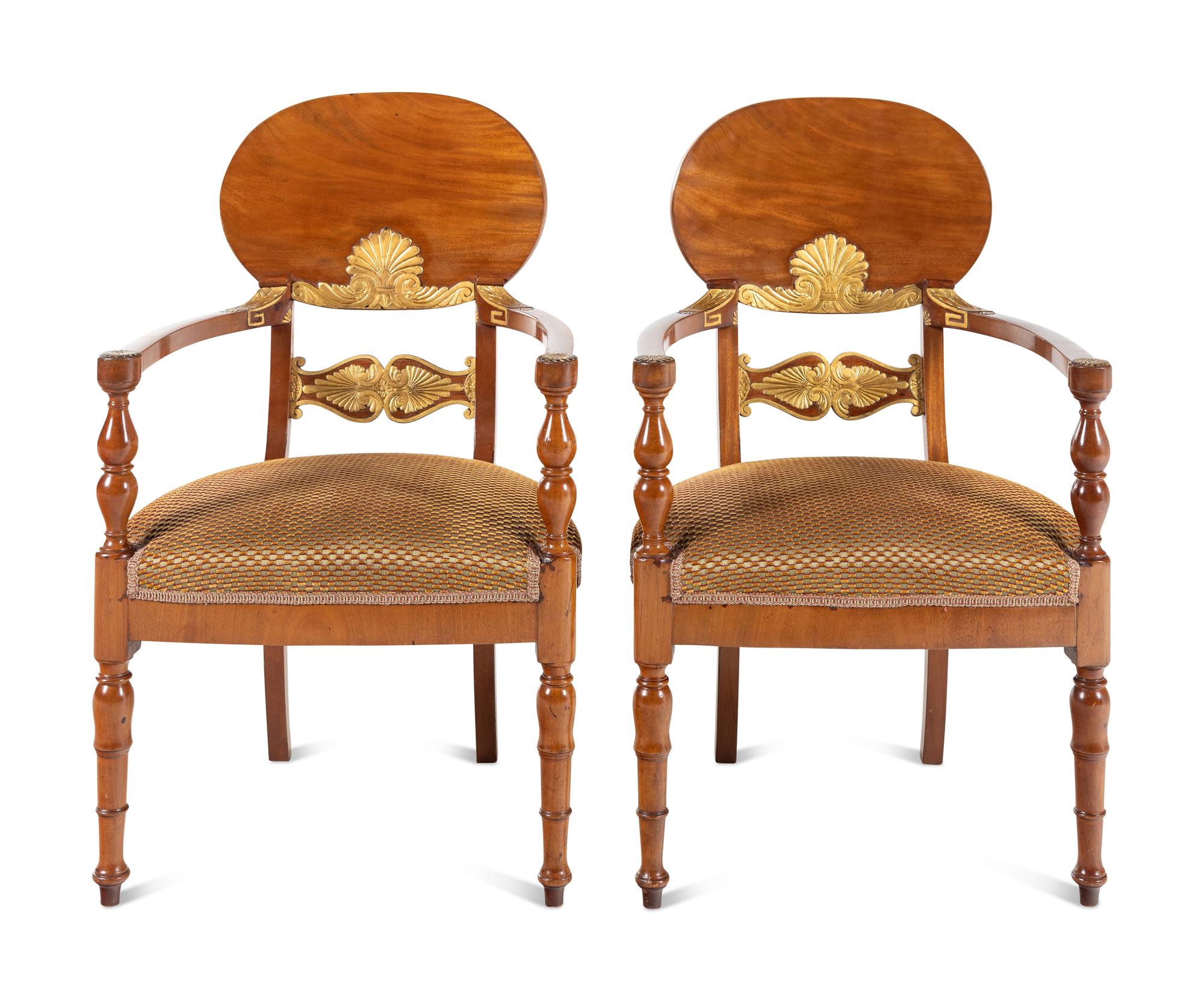 A Pair of Baltic Neoclassical Parcel-Gilt Walnut Armchairs