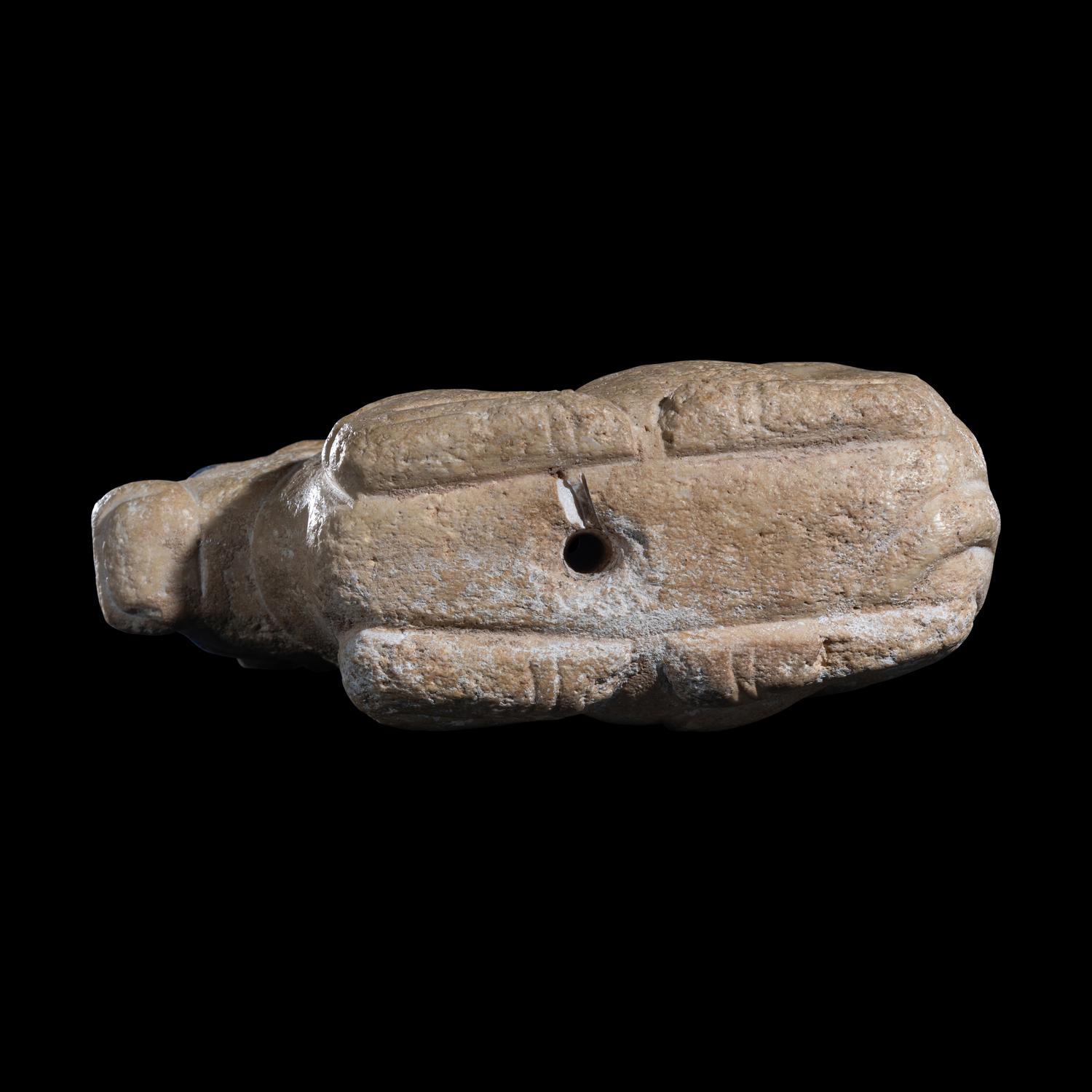 A Mesopotamian Limestone Recumbent Bull with Lapis Lazuli Inlays