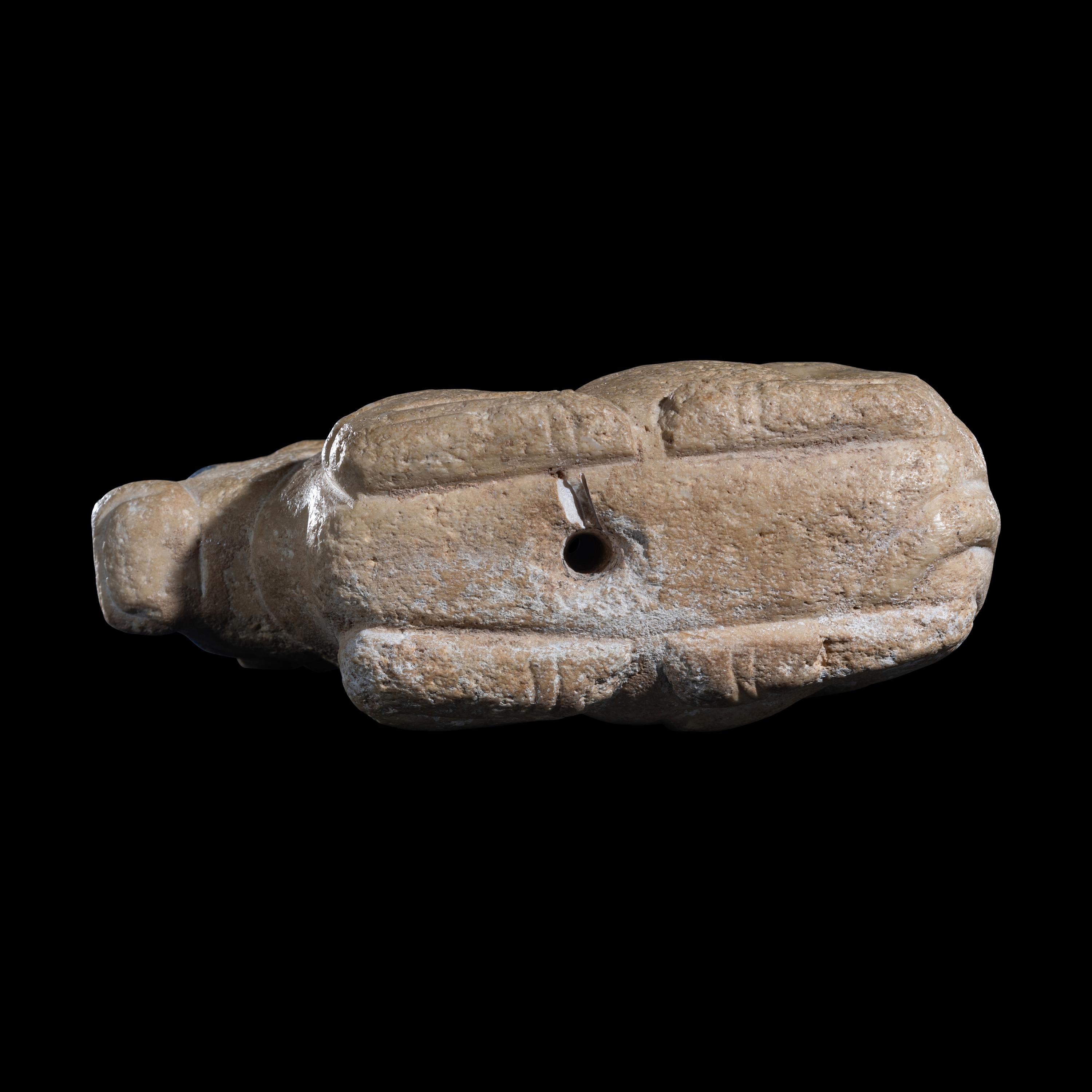 A Mesopotamian Limestone Recumbent Bull with Lapis Lazuli Inlays